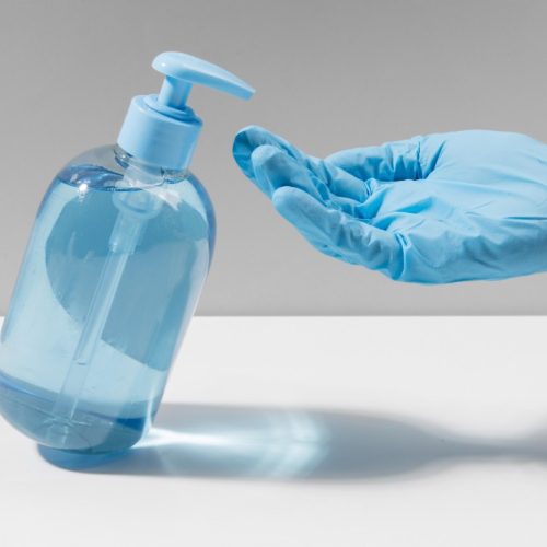 hand-with-surgical-glove-using-hand-sanitizer